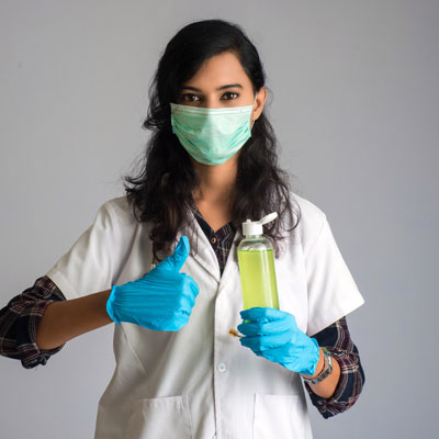 A woman doctor showing a bottle of sanitizing gel for hands cleaning